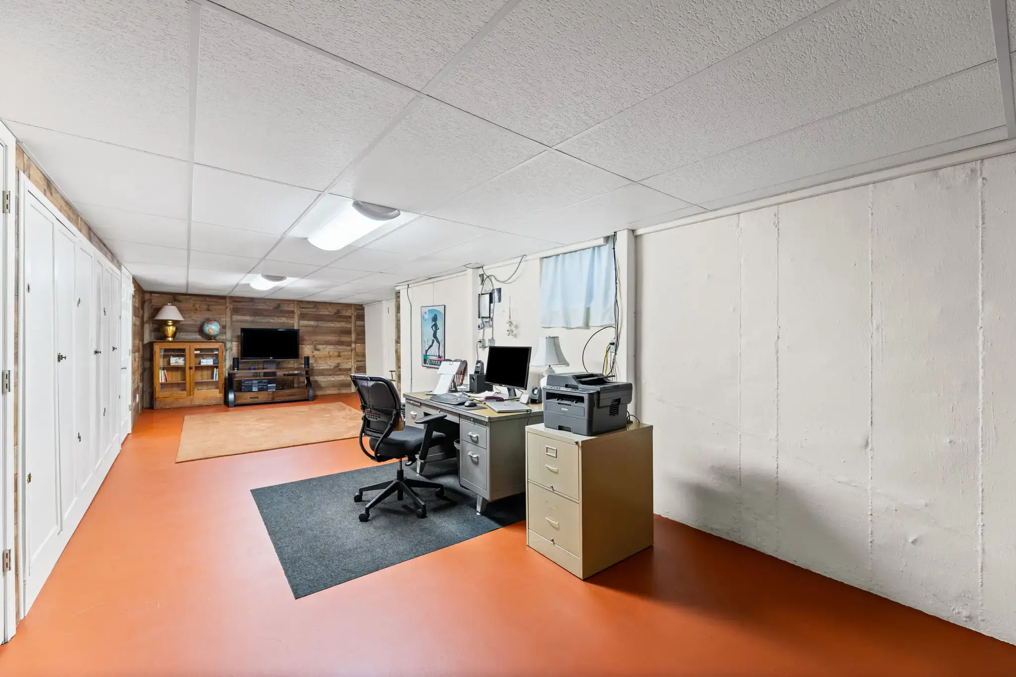 Lower level with an office area, storage closets and a rec room
